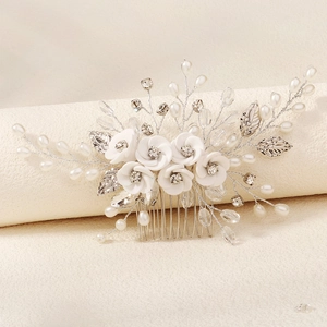 Detail of bridal hair comb with clay flowers, pearls, and crystals on silver wire