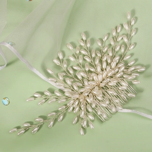 Close-up of bridal hair comb with marquise pearls and silver wire in branch design
