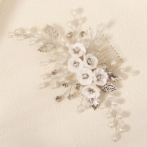 Elegant bridal hair comb with handmade white flowers, pearls, and crystals for wedding styling