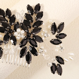 Detail of handcrafted bridal hair comb featuring black rhinestones and white pearls