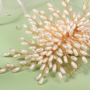 Detail of bridal hair comb with gold wire, marquise rhinestones and ivory pearls