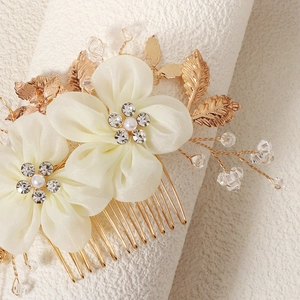 Detail of bridal hair comb with fabric flowers, faux pearls and sparkling crystals