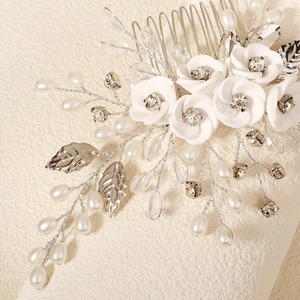 Close-up of bridal hair comb with handmade clay flowers, faux pearls and crystals