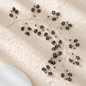 Detail of handcrafted bridal hair comb with black faceted beads and gold wire