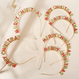 Detail of five Merry Christmas headbands with red and green rhinestones on gold metal frames