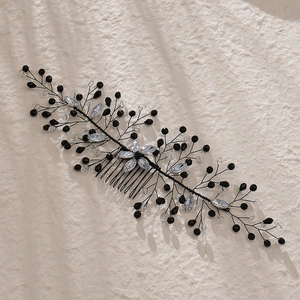Detailed macro view of handmade black crystal beads and bridal hair comb craftsmanship