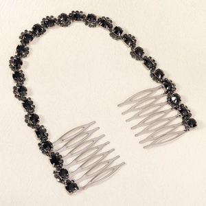 Detailed macro view of black rhinestone chain and silver bridal hair comb accessories