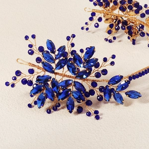 Detail of handcrafted gold wire headband with dark blue crystals and rhinestones