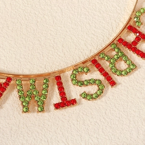 Macro detail of Christmas headband with Wish text and red green rhinestones