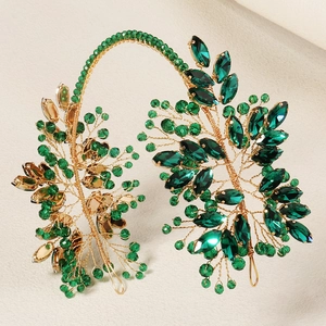 Detailed close-up of handmade bridal headband with green crystals and gold wire weaving