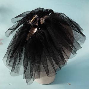 Elegant black bridal veil hair claw clip with layered mesh fabric on a display head