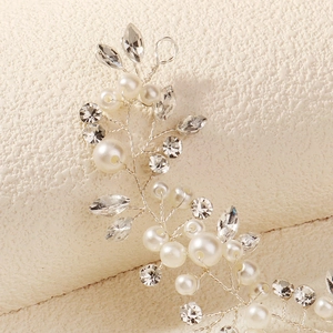 Detailed macro view of bridal hairband with crystal rhinestones and pearls