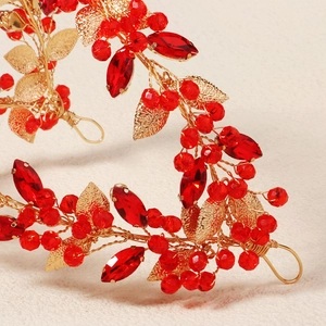 Handmade bridal headband with red crystals and gold metal leaves for wedding hairstyles