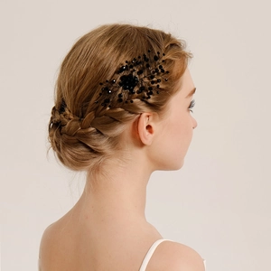 Elegant bridal hair comb with black beads and rhinestones shown on a bun hairstyle