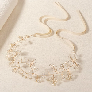 Détail d'un bandeau de mariée fait main avec fils d'or, perles, cristaux et rubans satin