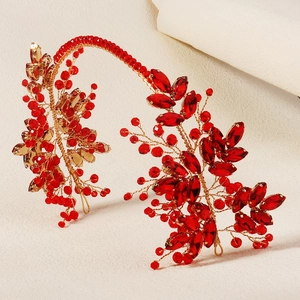 Detailed view of handmade bridal headband with red crystals and gold wire weaving