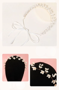 Close-up of handmade white flower bridal headband with gold wire and silk ribbons