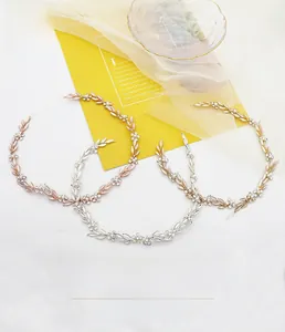 Detail of vintage bridal leaf headbands in gold, silver and rose gold with rhinestones