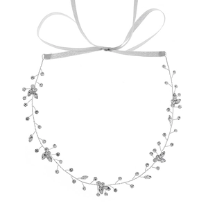 Elegant bridal hair vine with silver rhinestones and beads on white background
