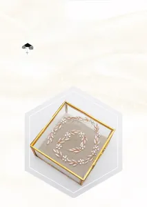 Detail view of rose gold leaf bridal headband with pearls in a glass jewelry box