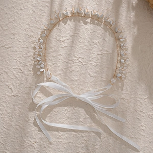 French bridal headband with white flowers and golden wire on a creamy texture background