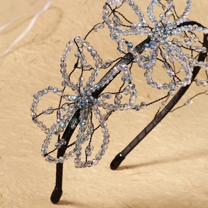 Detailed macro view of handcrafted floral headband featuring iridescent crystal bead flowers