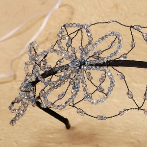 Close-up of handmade floral headband with crystal beads and intricate wire weaving detail