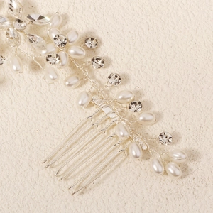 Detailed view of handmade silver bridal hair comb with pearls and rhinestones decoration