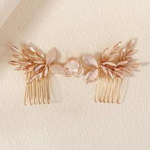 Detail of handcrafted gold leaf and flower hair comb with pearls for bridal hairstyles