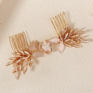 Detailed view of the golden alloy flower hair comb with pearls for bridal hairstyles