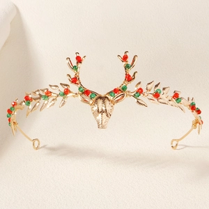 Detailed view of handmade Christmas elk tiara with golden antlers and red green beads