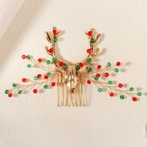 Detailed view of Christmas reindeer hair comb with red and green crystal beads on gold alloy