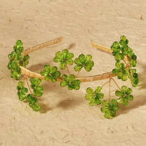Detail of handmade bridal headband with green crystal flowers and beige satin wrap