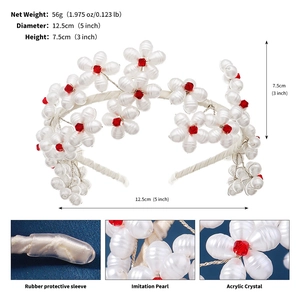 Macro view of handmade white pearl flower headband with red crystal center and rubber ends