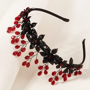 Gothic Halloween headband with black flowers and red crystal beads on white background