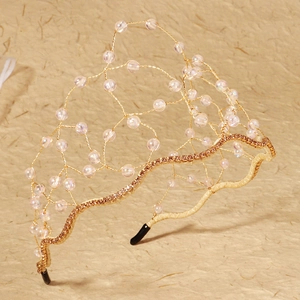 Detail view of handmade gold wire bridal crown with crystal beads and rhinestones