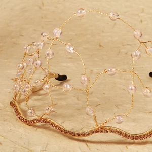 Detailed macro view of handmade gold wire bridal headband with iridescent crystals