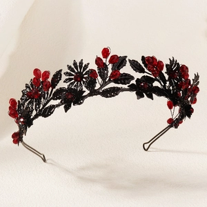 Close-up of Gothic crown with black metallic leaves and vibrant red crystal clusters