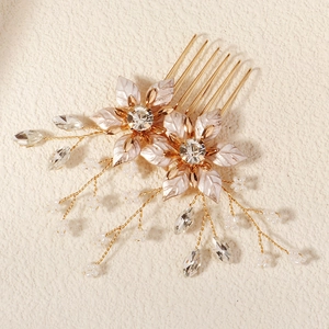 Elegant bridal hair comb with gold floral petals, white pearls and sparkling rhinestones