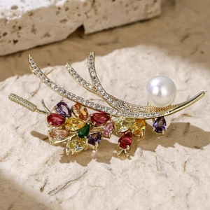 Detailed macro of wheat brooch with colorful gemstones, micro-pave zircons and white pearl