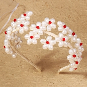 Luxurious handmade bridal headband featuring cream pearls and red crystal floral details