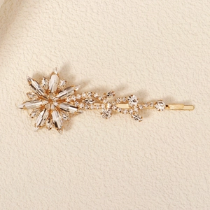 Detailed view of a gold starburst hair clip featuring marquise crystals and sparkling zircons