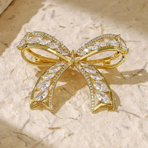 Macro shot of gold wheat ear brooch with zircons showing the back safety pin closure