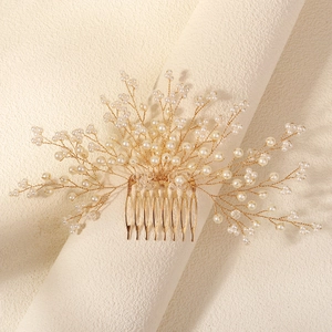 Detailed view of handmade bridal hair comb with pearls and crystals on gold wire