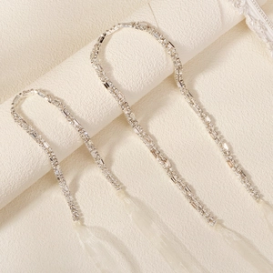 Luxurious double-row rhinestone bridal hair accessory with white organza ribbon on fabric