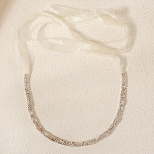 Detail of double-row crystal bridal belt with silver rhinestones and organza ribbon