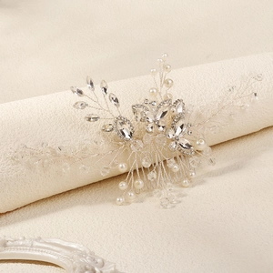 Detailed view of handmade bridal hair comb with crystal beads and white pearls