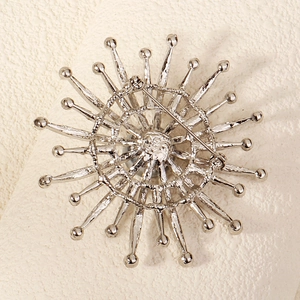 Elegant snowflake brooch in silver finish featuring detailed back safety pin structure