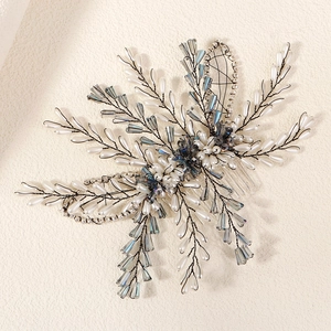 Close-up of handmade bridal hair comb with blue glass beads and white pearls