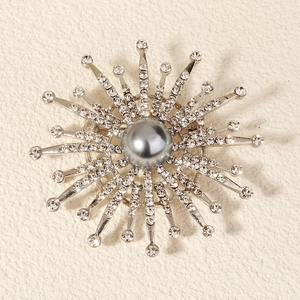 Elegant snowflake sunburst brooch with silver plating, grey pearl, and sparkling rhinestones